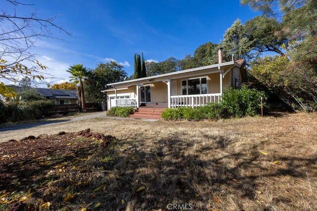 18686 Marine View Rd, Hidden Valley Lake, CA 95467 - view of front of house featuring a garage, concrete driveway, and covered porch
