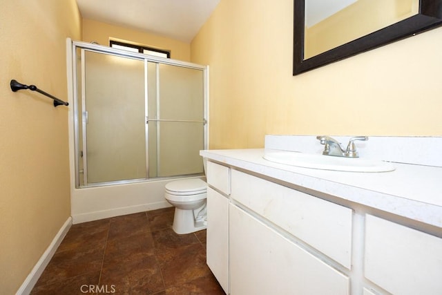 full bathroom featuring enclosed tub / shower combo, vanity, and toilet