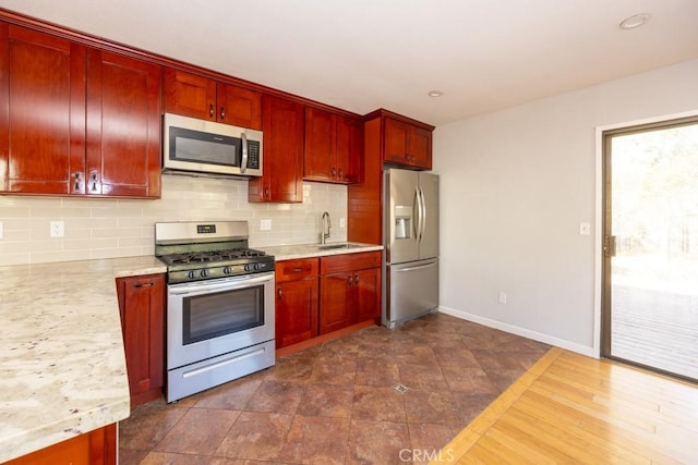 18686 Marine View Rd, Hidden Valley Lake, CA 95467 - kitchen featuring baseboards, backsplash, dark brown cabinets, appliances with stainless steel finishes, and a sink