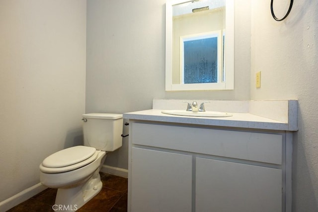 bathroom featuring vanity, tile patterned flooring, and toilet