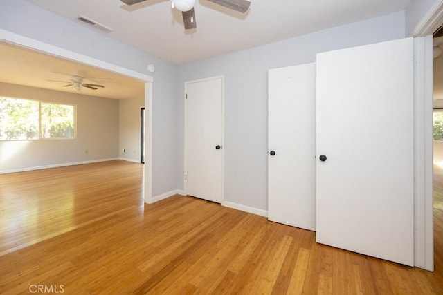 unfurnished bedroom with ceiling fan and light hardwood / wood-style flooring