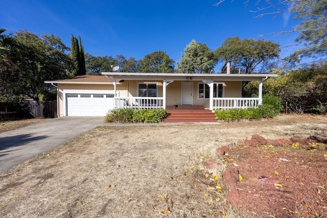 ranch-style house featuring a porch and a garage