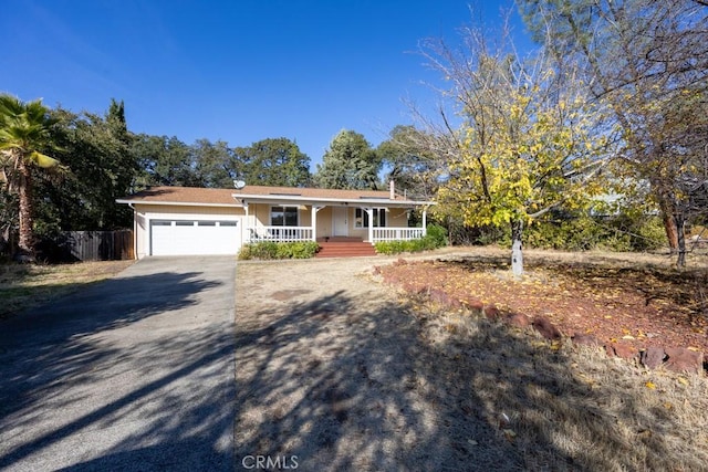 view of front of property featuring a porch and a garage