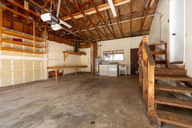 garage with sink, gas water heater, and washer and dryer