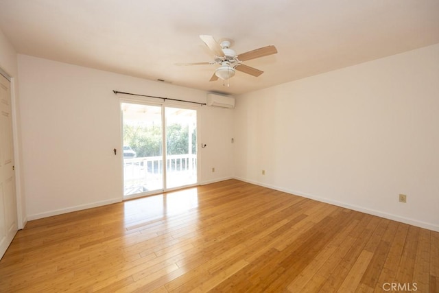 unfurnished room featuring ceiling fan, a wall unit AC, and light hardwood / wood-style floors