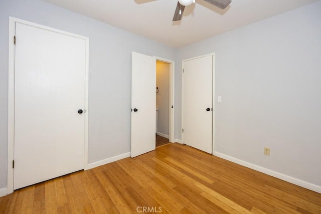 unfurnished bedroom featuring hardwood / wood-style flooring and ceiling fan