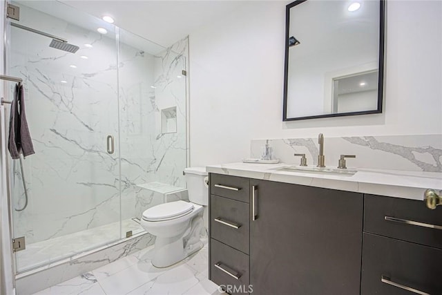 bathroom featuring vanity, an enclosed shower, and toilet