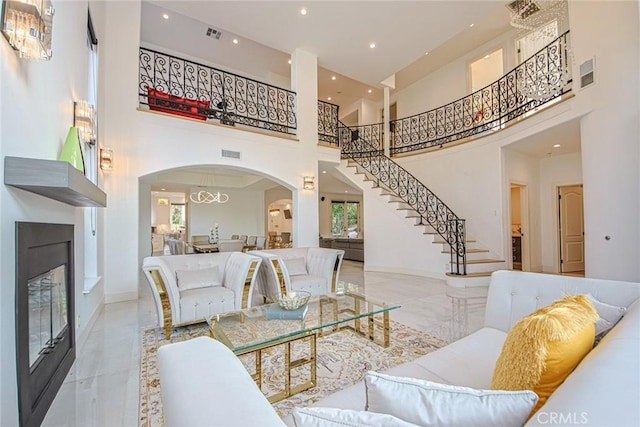 living room with a healthy amount of sunlight and a high ceiling