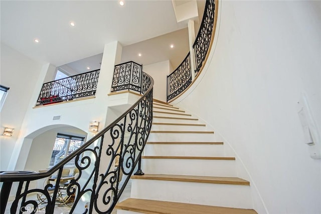 stairs featuring a high ceiling