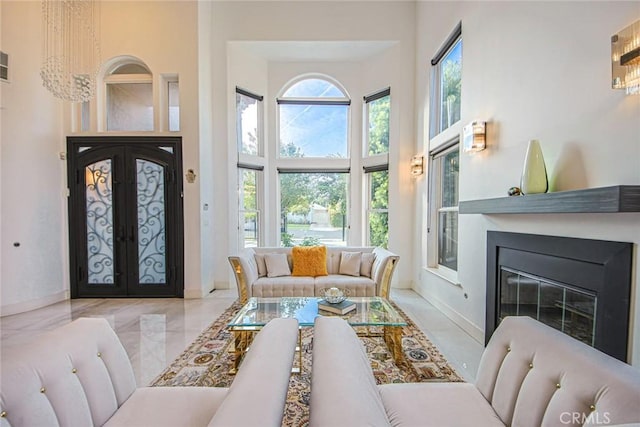 living room featuring french doors and a high ceiling