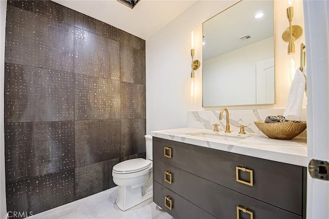 bathroom featuring vanity, backsplash, tile patterned floors, and toilet