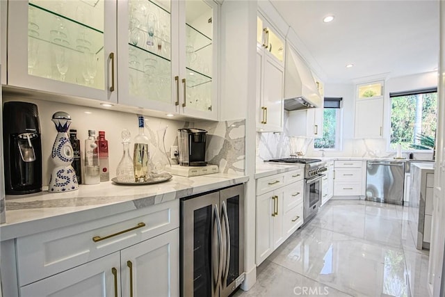 kitchen with white cabinetry, stainless steel appliances, and beverage cooler