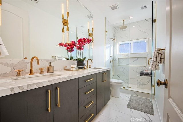 bathroom featuring vanity, toilet, and a shower with shower door