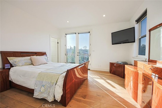 bedroom with light hardwood / wood-style flooring and access to outside