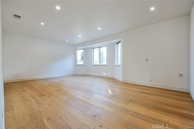 spare room featuring light wood-type flooring