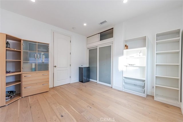 unfurnished bedroom featuring wood-type flooring and a closet