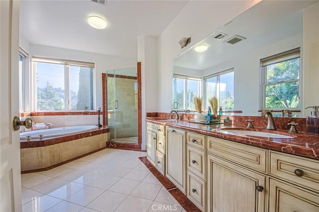 bathroom featuring plus walk in shower, tile patterned floors, and vanity