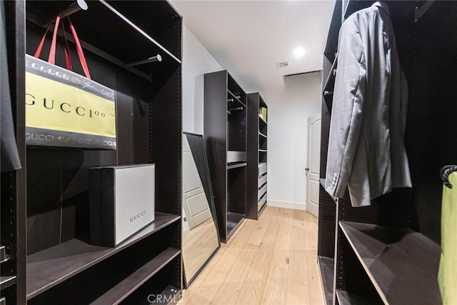 walk in closet featuring light hardwood / wood-style flooring