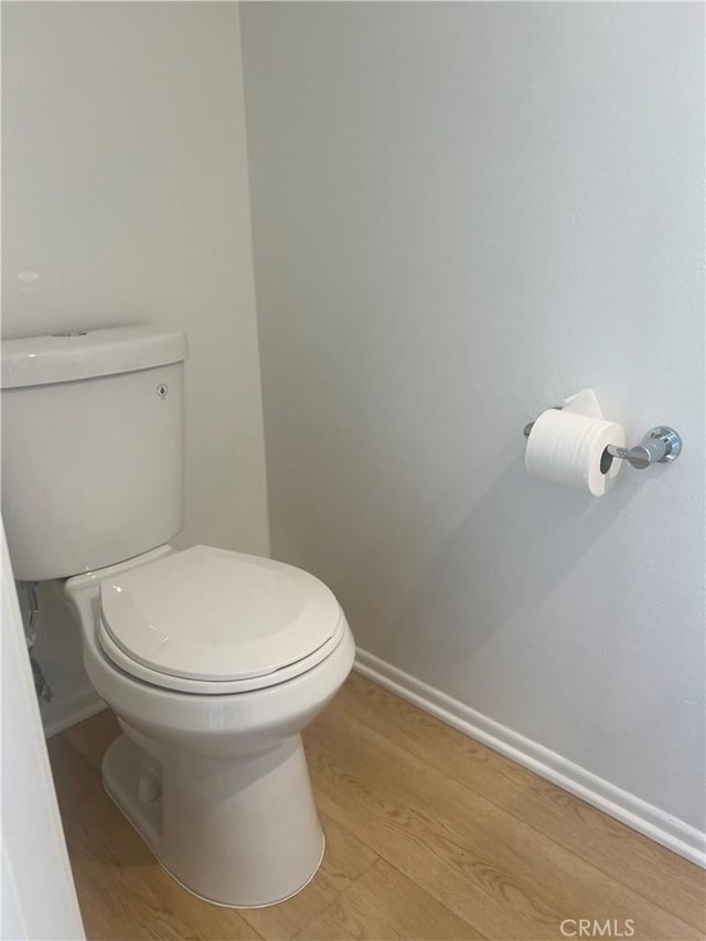 bathroom featuring hardwood / wood-style flooring and toilet