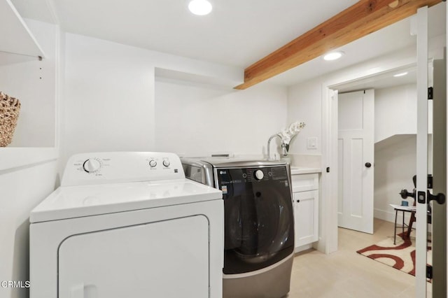 laundry room with cabinets and washing machine and dryer