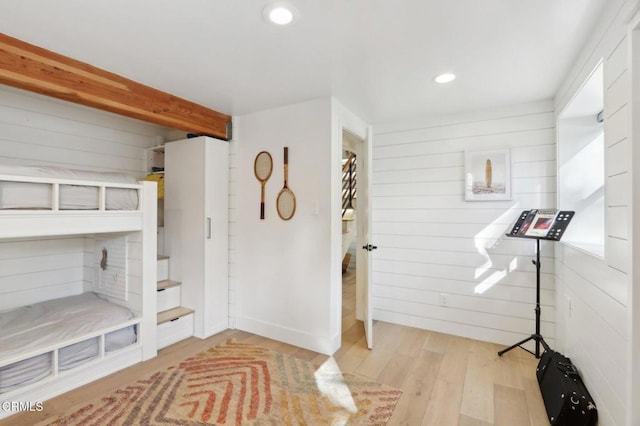 interior space featuring wooden walls and light hardwood / wood-style floors