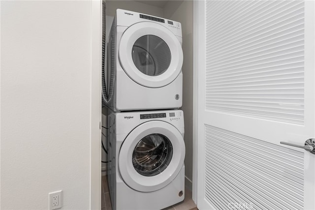 clothes washing area featuring stacked washer / drying machine