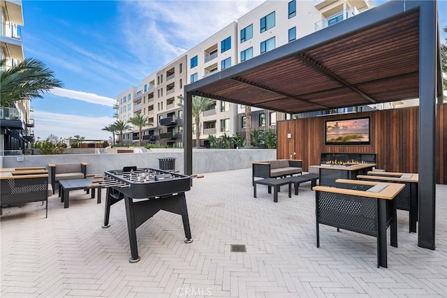 view of patio / terrace with an outdoor living space with a fire pit