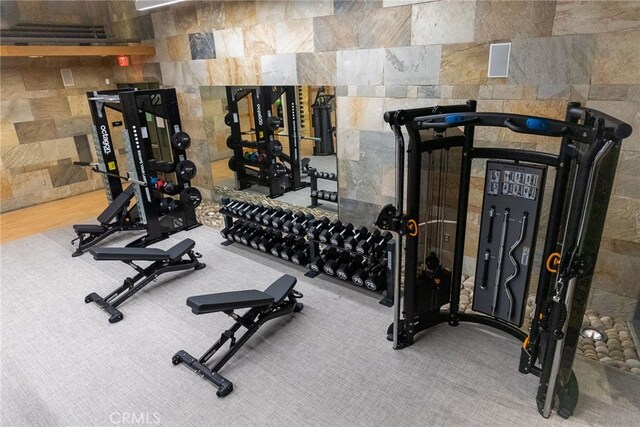 exercise area featuring tile walls