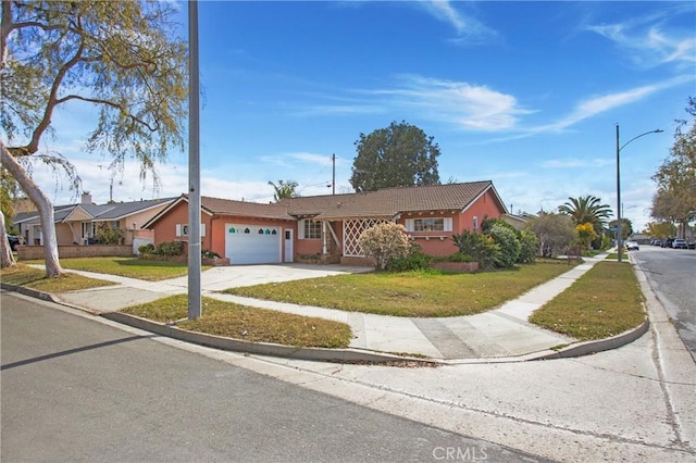 ranch-style house featuring a garage and a front lawn