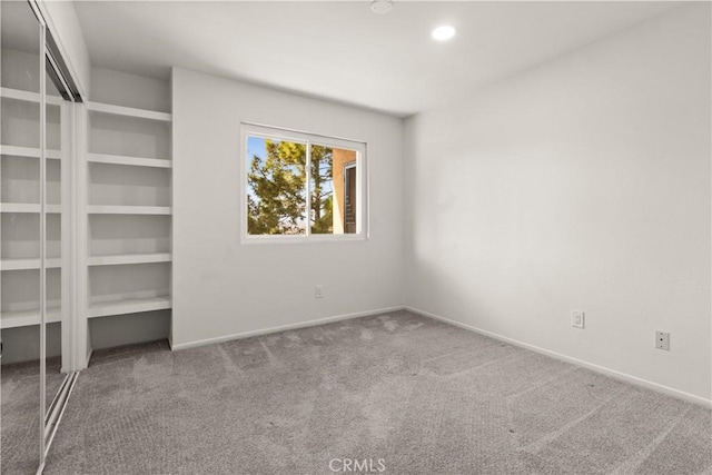 unfurnished bedroom with carpet floors, baseboards, a closet, and recessed lighting