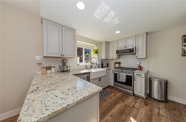 36763 Venado Dr, Coarsegold, CA 93614 - kitchen featuring stainless steel appliances, backsplash, dark wood-style flooring, light stone countertops, and recessed lighting