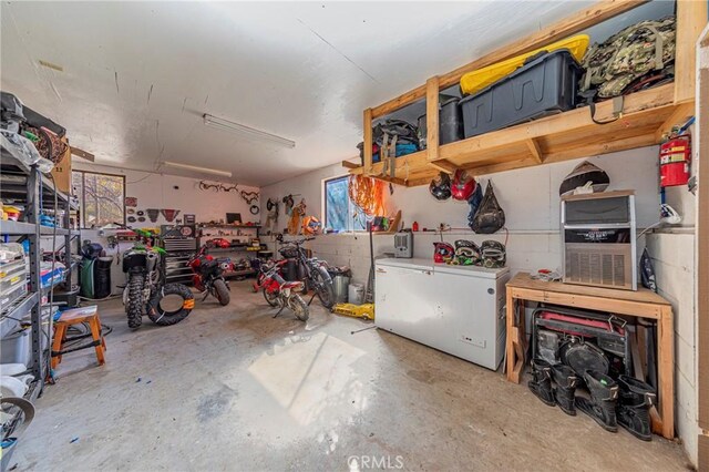 36763 Venado Dr, Coarsegold, CA 93614 - garage featuring a workshop area and refrigerator