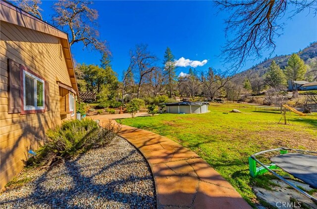 36763 Venado Dr, Coarsegold, CA 93614 - view of green lawn with a mountain view and a covered pool