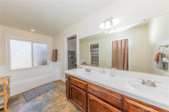 36763 Venado Dr, Coarsegold, CA 93614 - full bathroom featuring double vanity, stone finish floors, and a tub to relax in