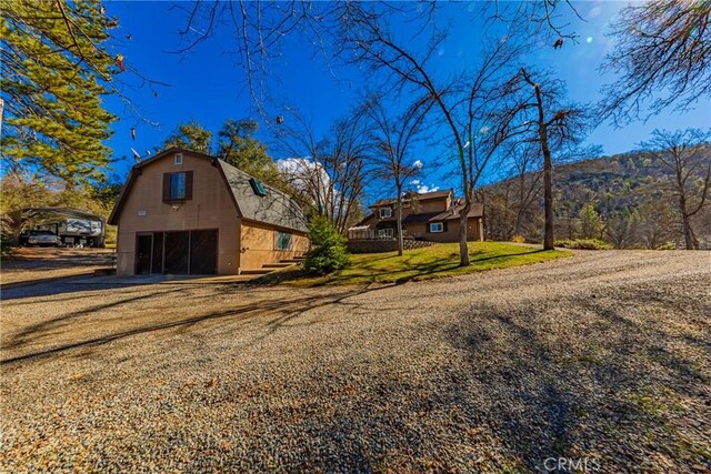 36763 Venado Dr, Coarsegold, CA 93614 - view of front facade featuring a detached garage, a barn, a gambrel roof, an outbuilding, and a mountain view