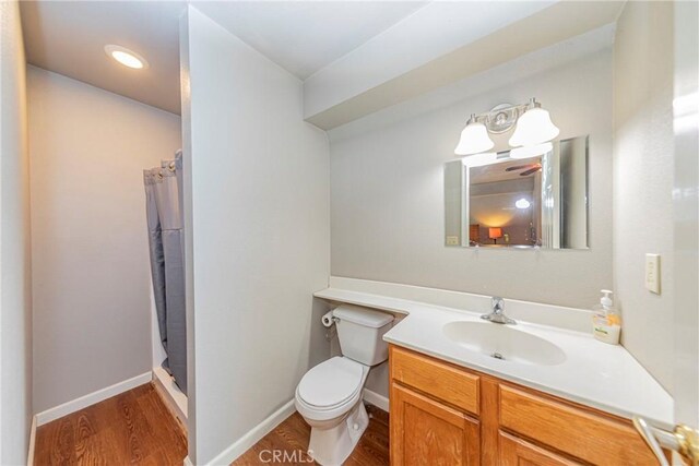 36763 Venado Dr, Coarsegold, CA 93614 - full bath with vanity, wood finished floors, a shower with shower curtain, and recessed lighting