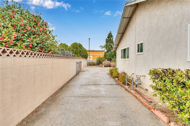 view of home's exterior featuring fence and stucco siding