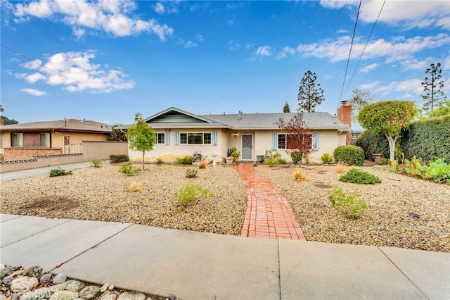 single story home featuring fence and a chimney