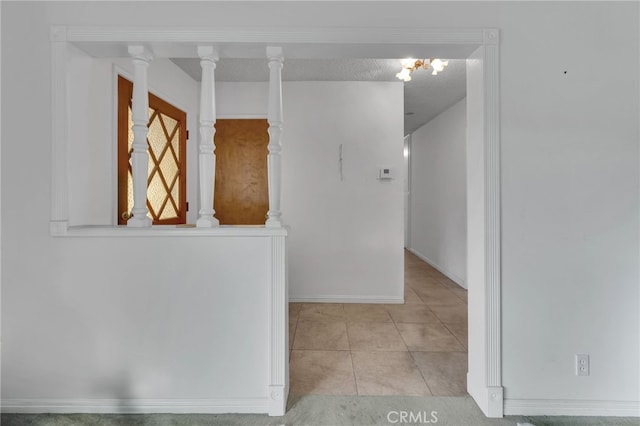 hall featuring stairway, a textured ceiling, and tile patterned floors