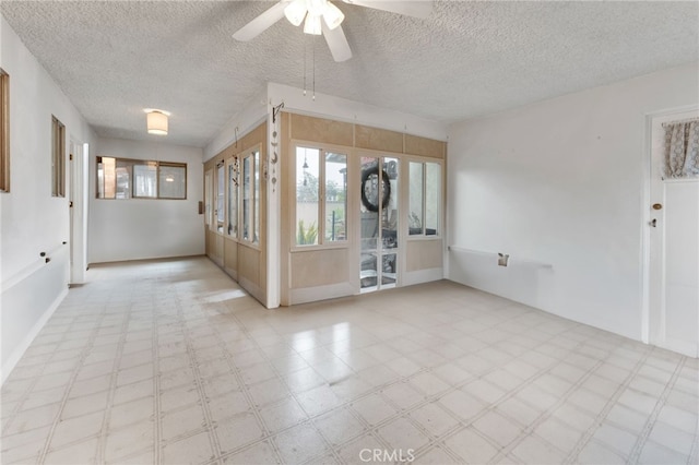 unfurnished room featuring a textured ceiling, a ceiling fan, and tile patterned floors