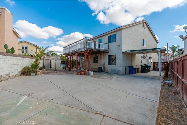 back of property featuring a patio area, central air condition unit, and a storage unit