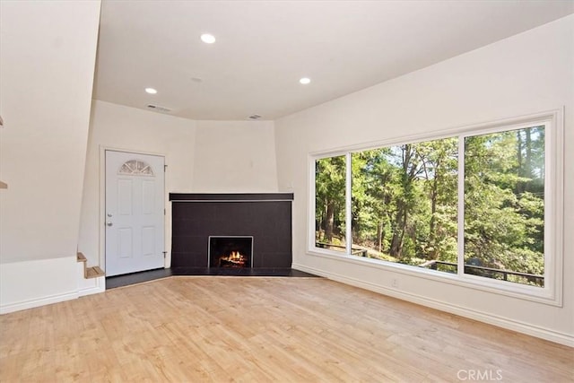 unfurnished living room with light hardwood / wood-style flooring