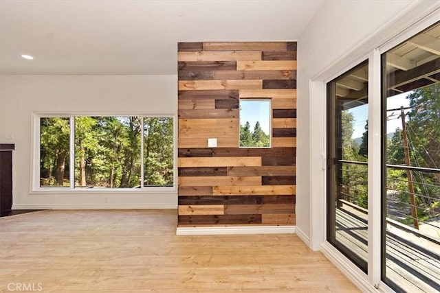 entryway with wooden walls and light wood-type flooring