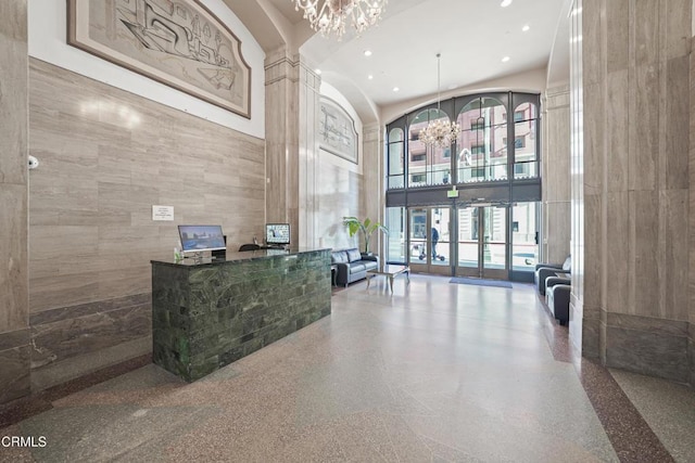 reception area featuring a chandelier and ornate columns