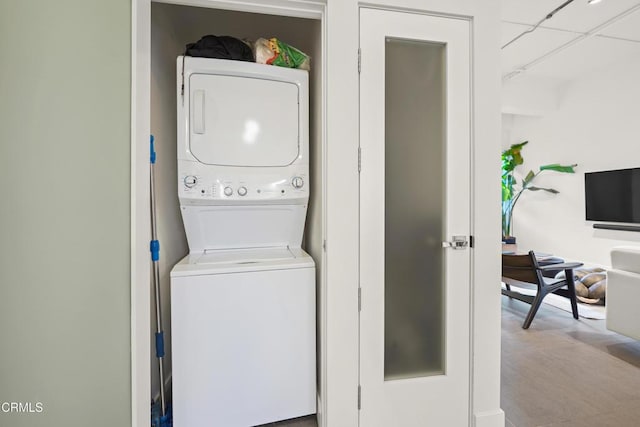 laundry area with stacked washing maching and dryer