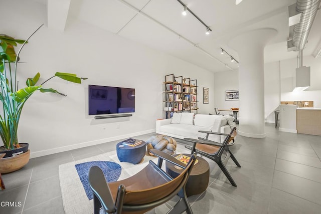 living room featuring light tile patterned floors and track lighting