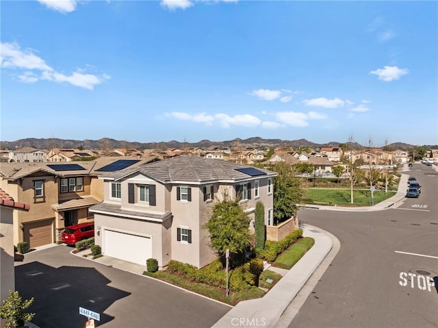 view of road with a residential view, sidewalks, a mountain view, and curbs