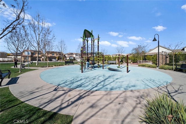 view of home's community with playground community, fence, and a residential view