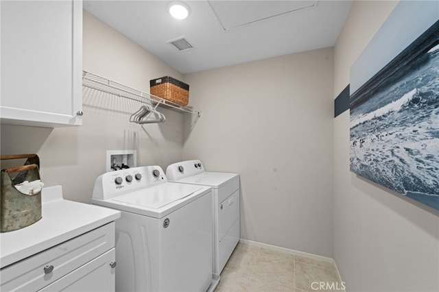 laundry area with light tile patterned floors, washing machine and dryer, visible vents, baseboards, and cabinet space