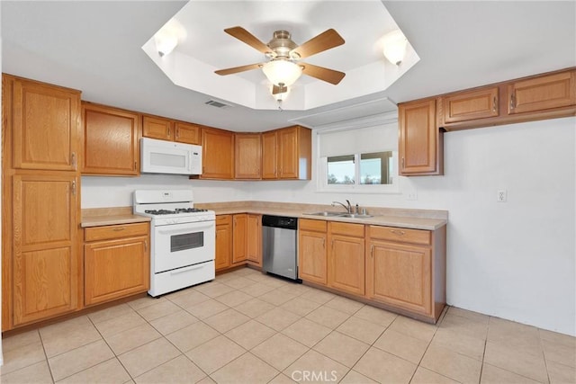 kitchen featuring sink, light tile patterned floors, ceiling fan, a tray ceiling, and white appliances